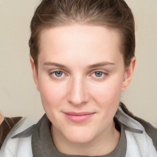 Joyful white young-adult female with short  brown hair and blue eyes