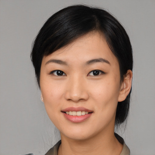Joyful asian young-adult female with medium  black hair and brown eyes