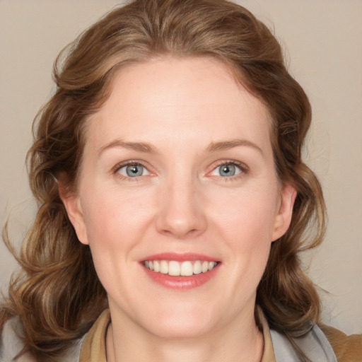 Joyful white young-adult female with medium  brown hair and blue eyes