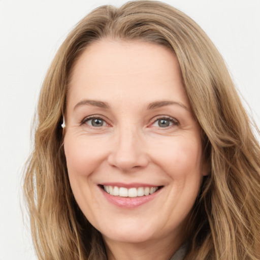 Joyful white adult female with long  brown hair and brown eyes