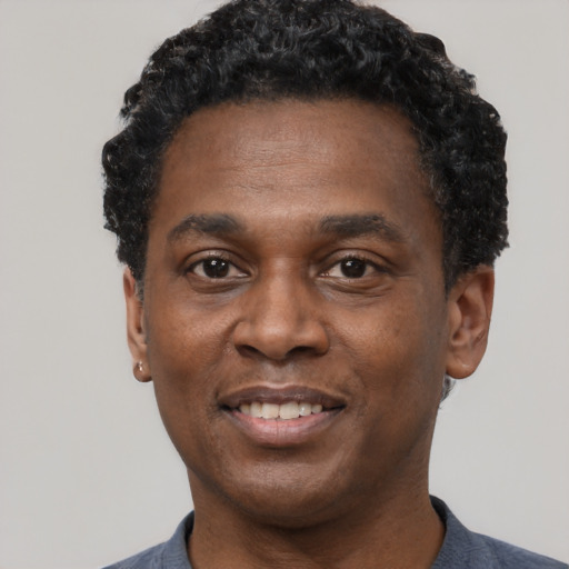 Joyful latino adult male with short  black hair and brown eyes