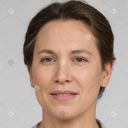 Joyful white adult female with short  brown hair and grey eyes