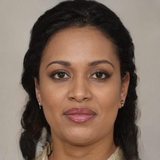 Joyful black adult female with medium  brown hair and brown eyes