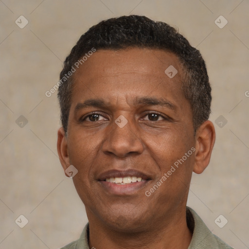 Joyful black adult male with short  black hair and brown eyes