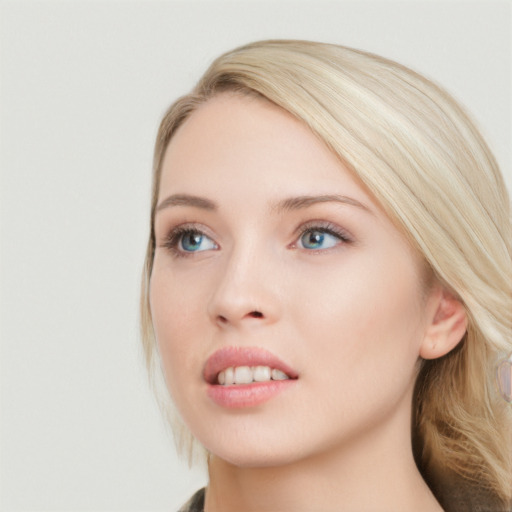 Joyful white young-adult female with long  brown hair and blue eyes