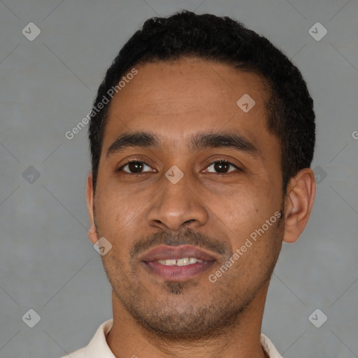 Joyful latino young-adult male with short  black hair and brown eyes