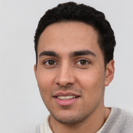 Joyful white young-adult male with short  black hair and brown eyes