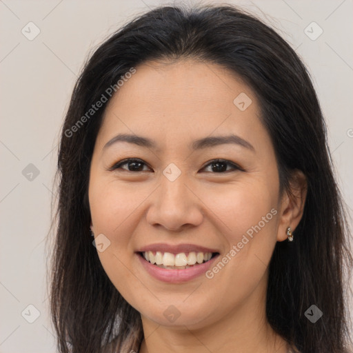 Joyful asian young-adult female with long  brown hair and brown eyes