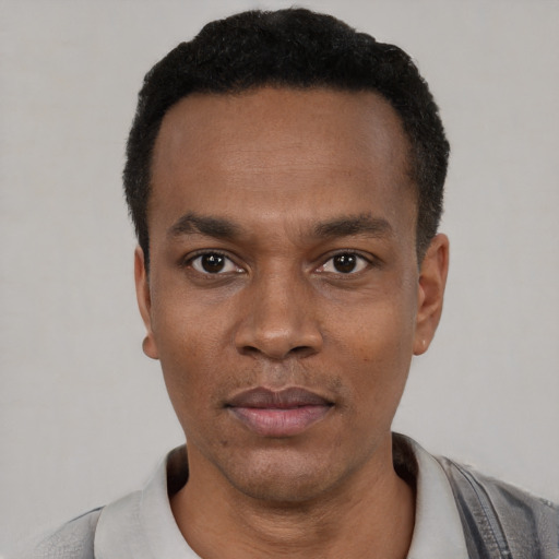 Neutral black young-adult male with short  black hair and brown eyes