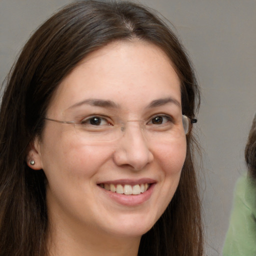 Joyful white adult female with long  brown hair and brown eyes