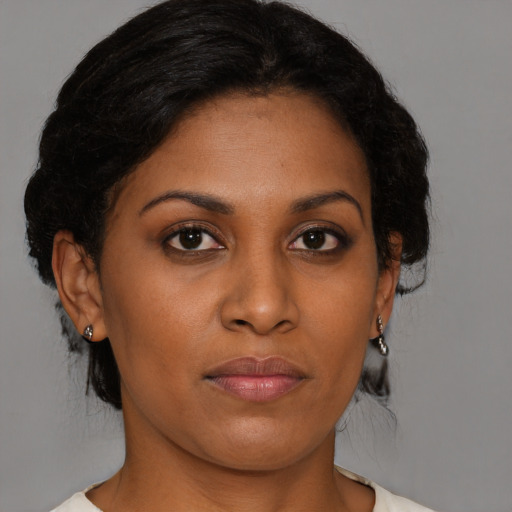 Joyful black young-adult female with medium  brown hair and brown eyes
