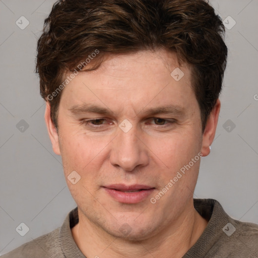 Joyful white adult male with short  brown hair and grey eyes