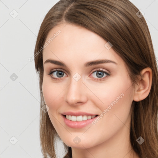 Joyful white young-adult female with long  brown hair and grey eyes