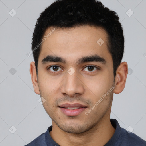 Joyful latino young-adult male with short  black hair and brown eyes