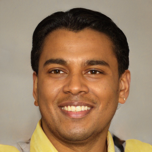 Joyful latino young-adult male with short  black hair and brown eyes
