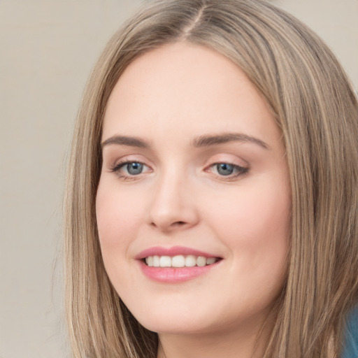 Joyful white young-adult female with long  brown hair and green eyes