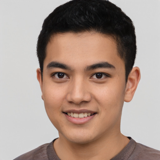 Joyful asian young-adult male with short  black hair and brown eyes