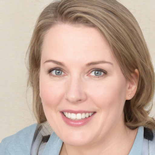 Joyful white young-adult female with medium  brown hair and blue eyes