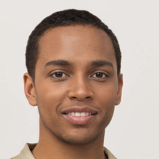 Joyful black young-adult male with short  brown hair and brown eyes