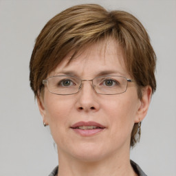 Joyful white adult female with medium  brown hair and grey eyes