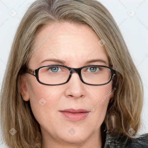 Joyful white adult female with medium  brown hair and blue eyes