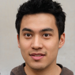 Joyful asian young-adult male with short  black hair and brown eyes