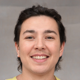 Joyful white young-adult male with medium  brown hair and brown eyes