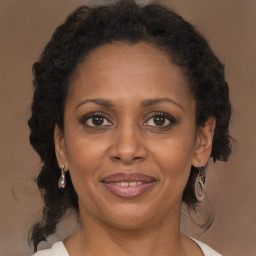 Joyful black adult female with medium  brown hair and brown eyes