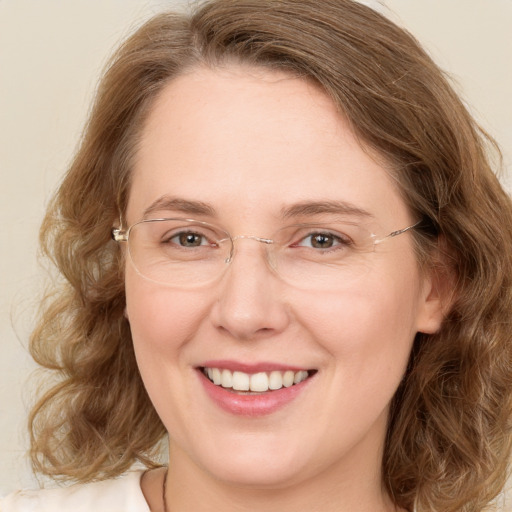 Joyful white adult female with medium  brown hair and green eyes