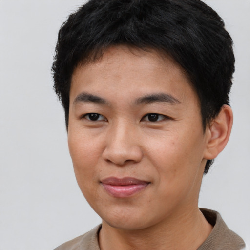 Joyful asian young-adult male with short  brown hair and brown eyes