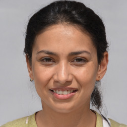 Joyful white adult female with medium  brown hair and brown eyes