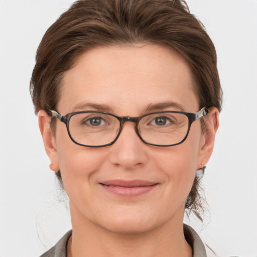 Joyful white adult female with short  brown hair and grey eyes