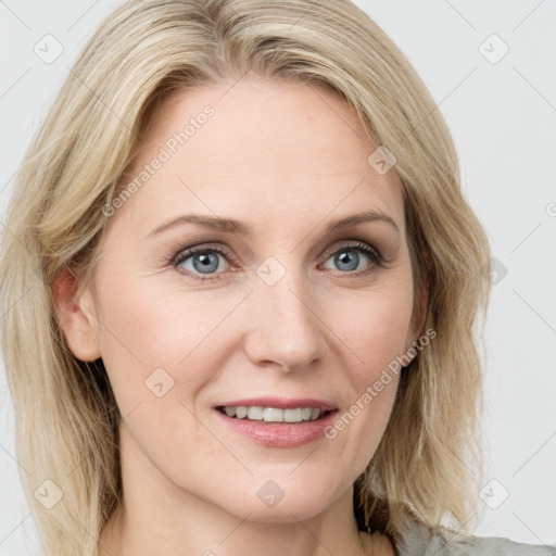 Joyful white adult female with long  brown hair and blue eyes