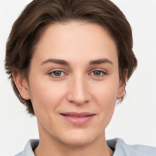 Joyful white young-adult female with short  brown hair and grey eyes