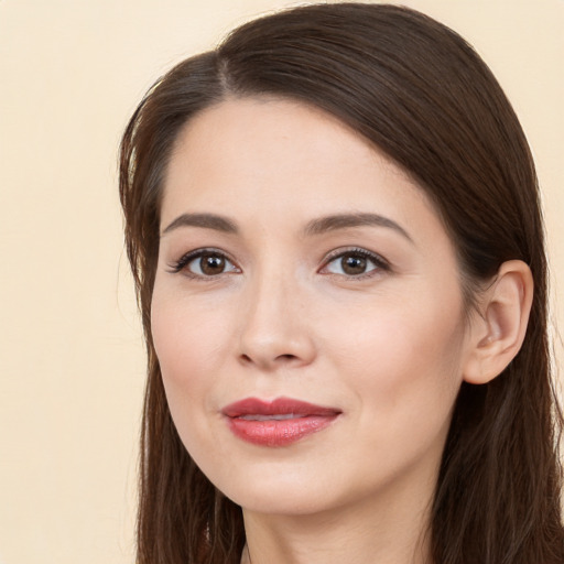 Joyful white young-adult female with long  brown hair and brown eyes