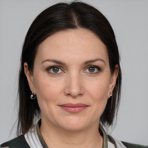 Joyful white adult female with medium  brown hair and grey eyes