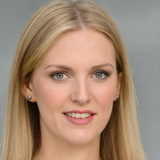 Joyful white young-adult female with long  brown hair and blue eyes