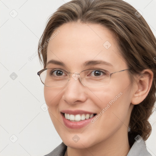 Joyful white adult female with medium  brown hair and grey eyes