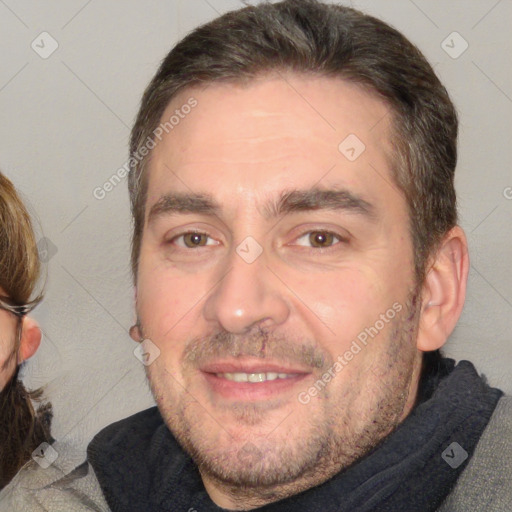 Joyful white adult male with short  brown hair and brown eyes