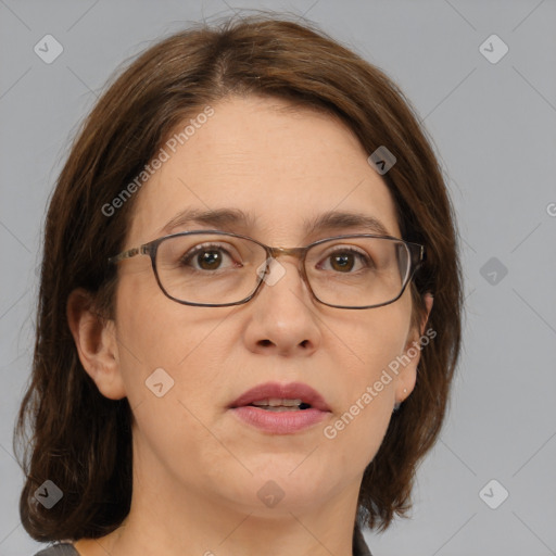 Joyful white adult female with medium  brown hair and blue eyes