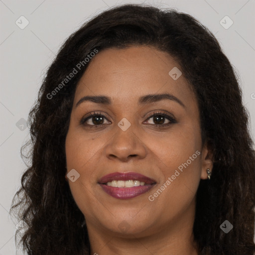 Joyful black adult female with long  brown hair and brown eyes