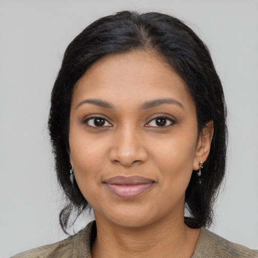 Joyful black young-adult female with long  black hair and brown eyes