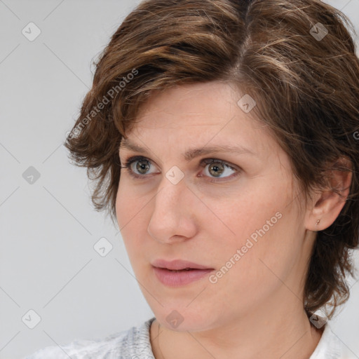 Joyful white adult female with medium  brown hair and grey eyes