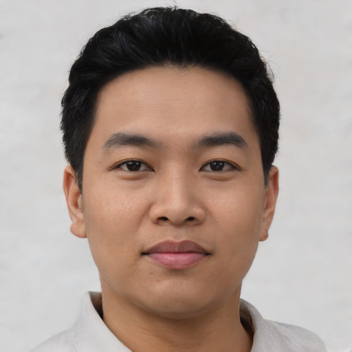 Joyful asian young-adult male with short  black hair and brown eyes