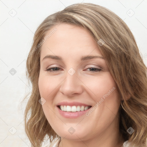 Joyful white young-adult female with long  brown hair and blue eyes