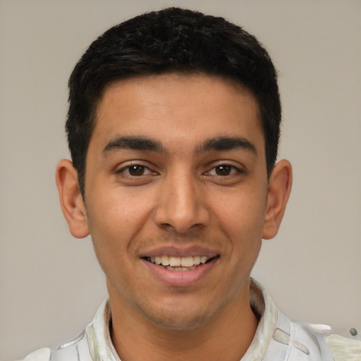 Joyful latino young-adult male with short  black hair and brown eyes