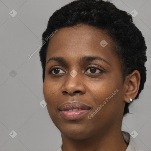 Joyful black young-adult female with short  black hair and brown eyes