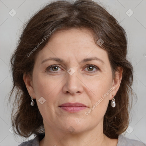 Joyful white adult female with medium  brown hair and grey eyes