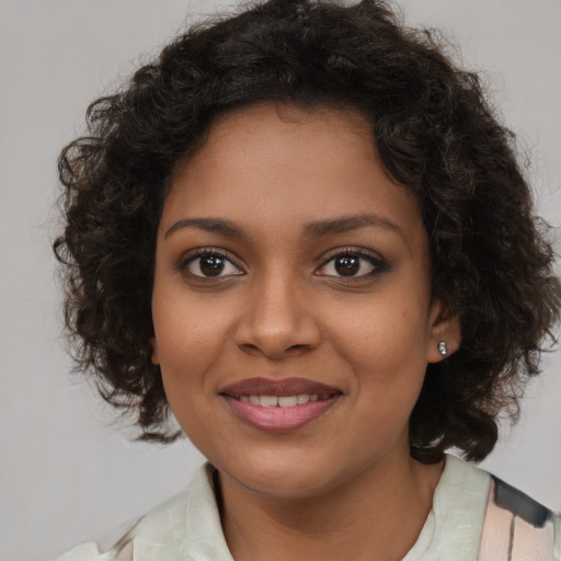 Joyful black young-adult female with medium  brown hair and brown eyes