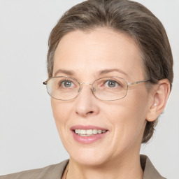 Joyful white adult female with medium  brown hair and brown eyes